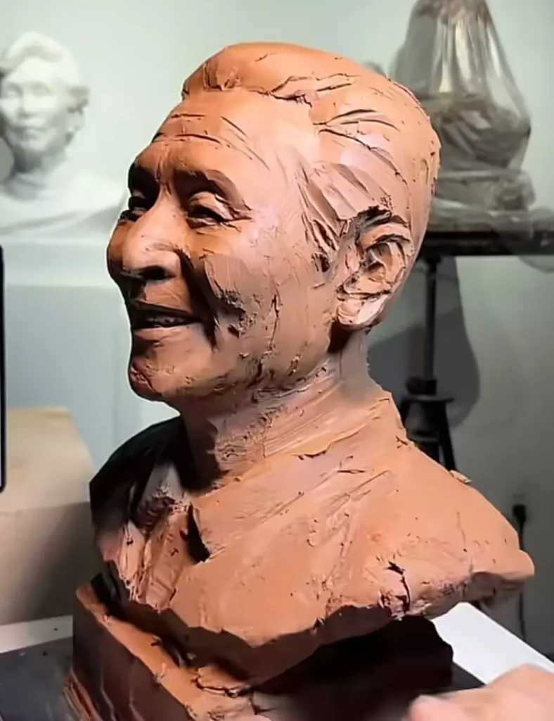 Detailed side view of the custom memorial bronze bust for a smiling elderly man, capturing the subtle contours of his face and the soft lines that form his smile.