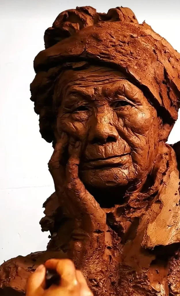 Close-up view of the sculptor refining the clay bust, capturing the elderly lady’s thoughtful gaze, weathered facial lines, and gentle expression