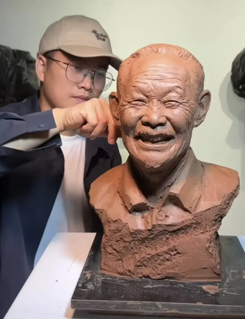 The sculptor at work on the custom memorial bronze bust for an elderly man, capturing his iconic, joyful smile in clay.
