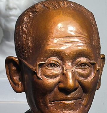 Close-up of custom brass statue finished details, clearly showing the figure's eyebrows,